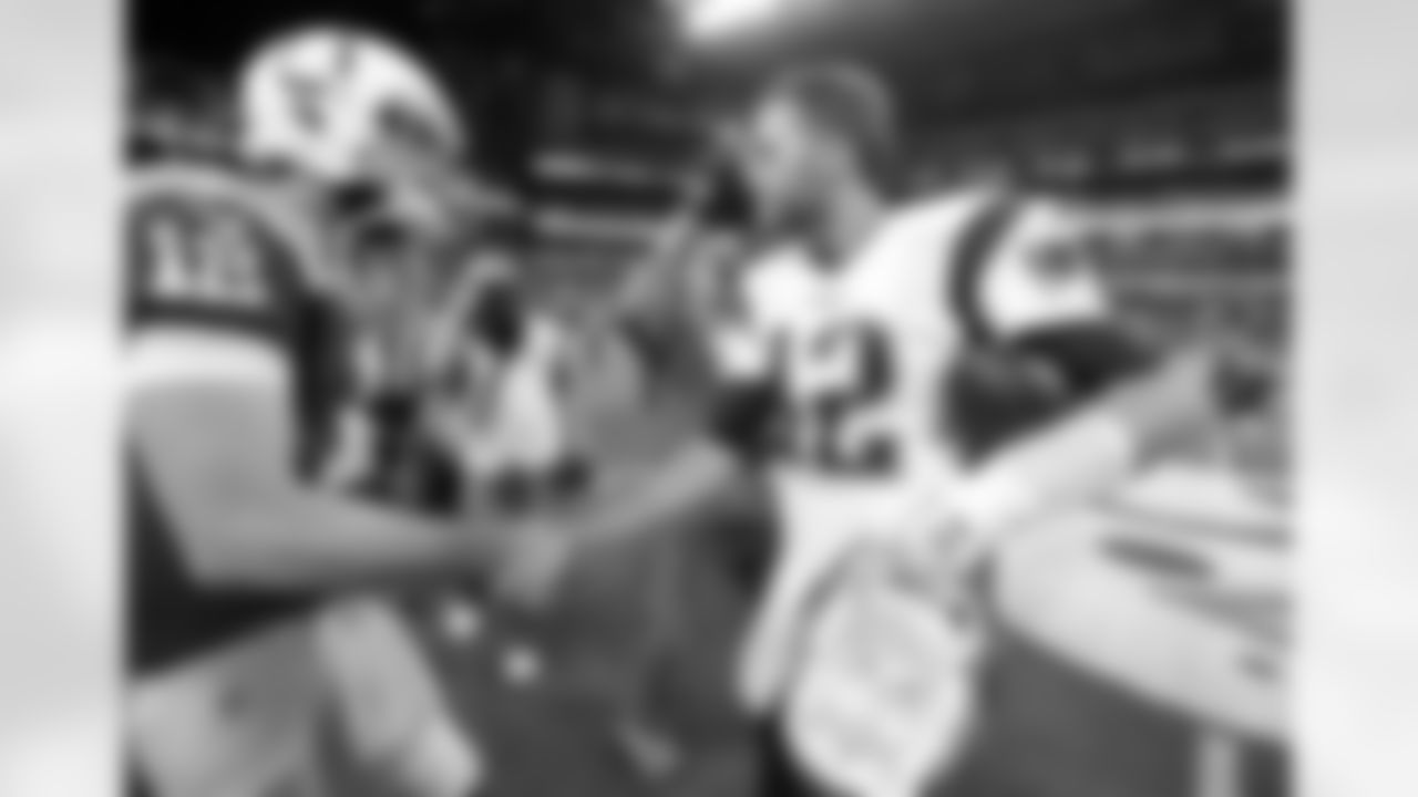 Indianapolis Colts quarterback Andrew Luck, left, and New England Patriots quarterback Tom Brady shake hands following an NFL football game in Indianapolis, Sunday, Oct. 18, 2015. The Patriots won 34-27. (AP Photo/Michael Conroy)