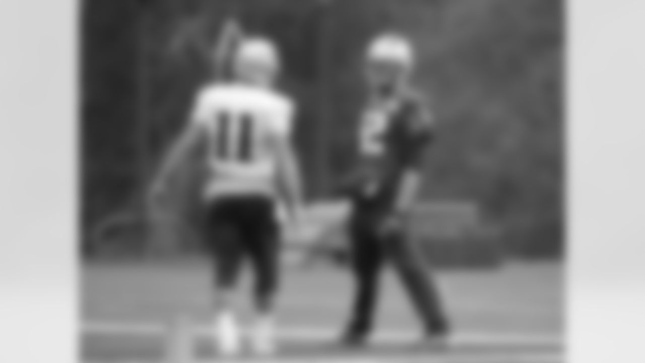 New England Patriots wide receiver Julian Edelman, left, speaks with Patriots quarterback Tom Brady, right, during an NFL football practice, Wednesday, Oct. 21, 2015, in Foxborough, Mass. The New York Jets are to play the Patriots Sunday, Oct. 25 in Foxborough. (AP Photo/Steven Senne)