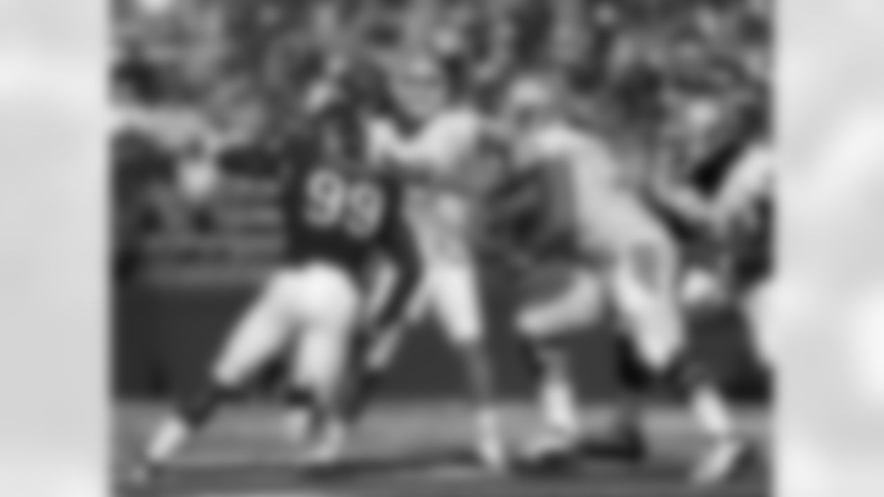 North Carolina quarterback  T.J. Yates (13) passes the ball under pressure by Rutgers defensive end Jonathan Freeny (99) during the first half of an NCAA college football game  Saturday, Sept. 25, 2010, in Piscataway, N.J.  (AP Photo/Mel Evans)