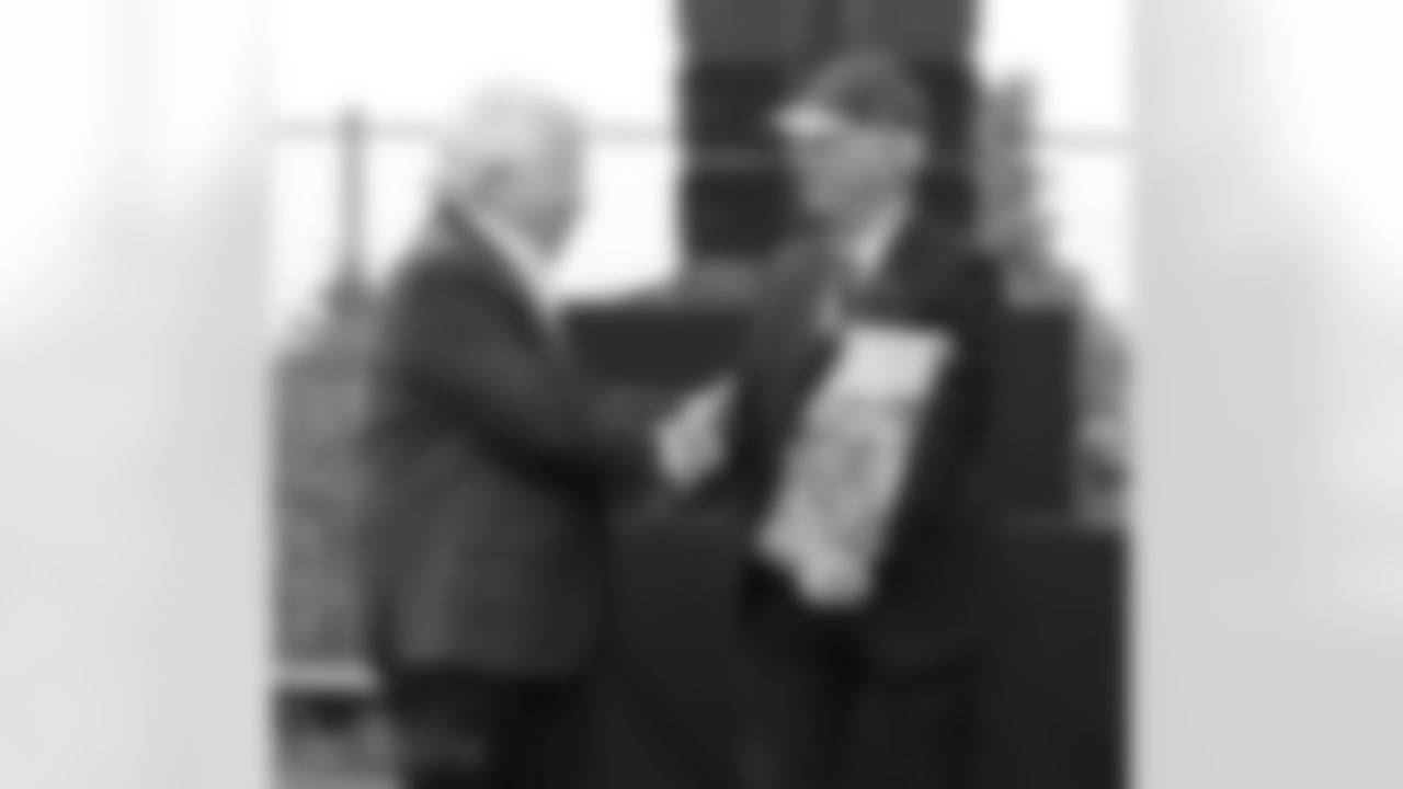 Robert Kraft is presnted with a gift by American Football of Israel (AFI) President Steve Leibowitz at the Kraft Family Stadium.