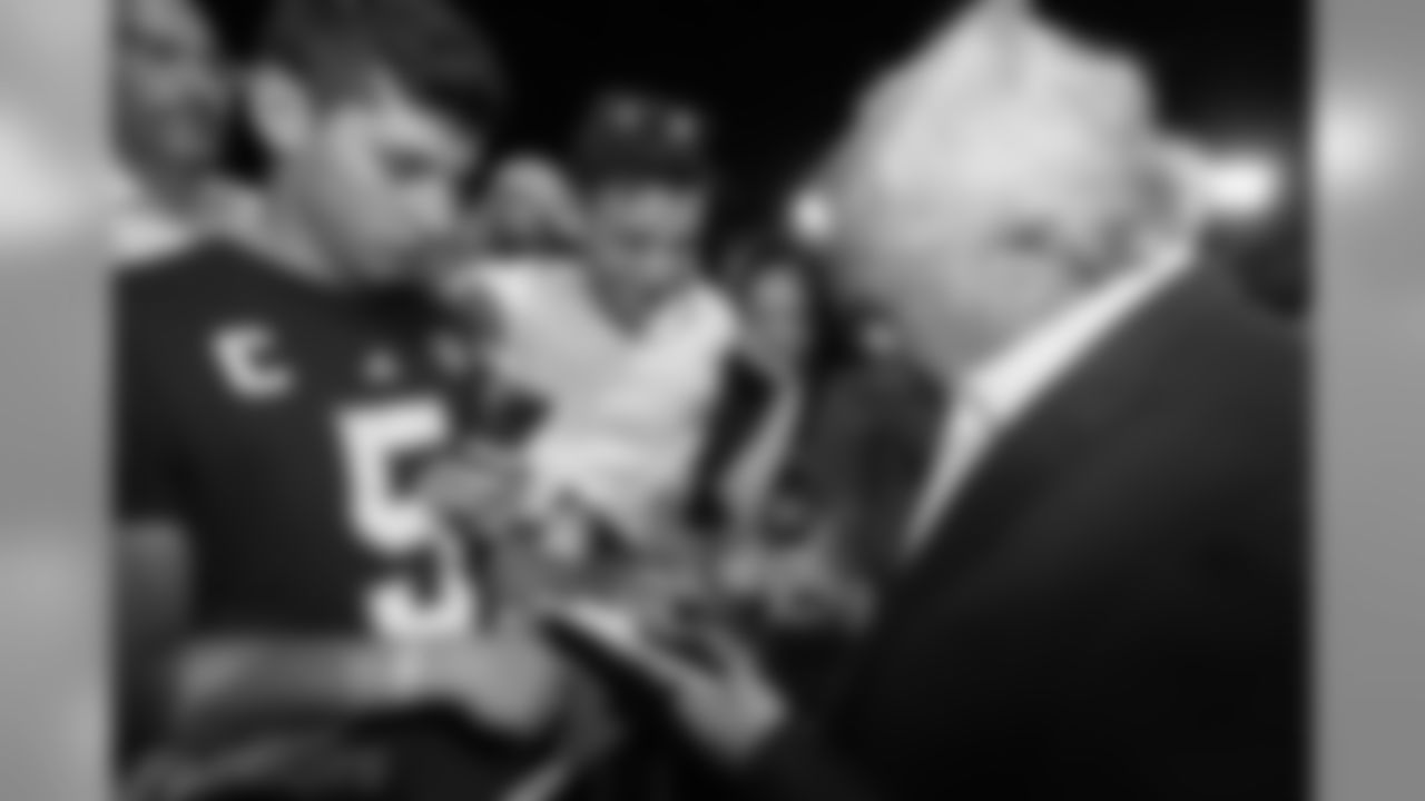 A young fan has a photo of himself with Robert Kraft autographed by the Patriots owner.