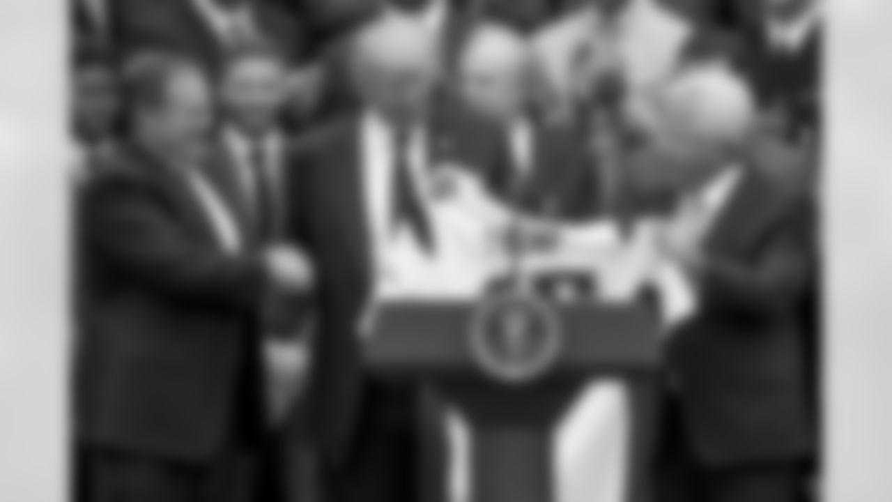 President Donald Trump is presented with a New England Patriots jersey by Patriots head coach Bill Belichick, left, and New England Patriots owner Robert Kraft during a ceremony on the South Lawn of the White House in Washington, Wednesday, April 19, 2017, where the president honored the Super Bowl Champion New England Patriots for their Super Bowl LI victory. (AP Photo/Andrew Harnik)