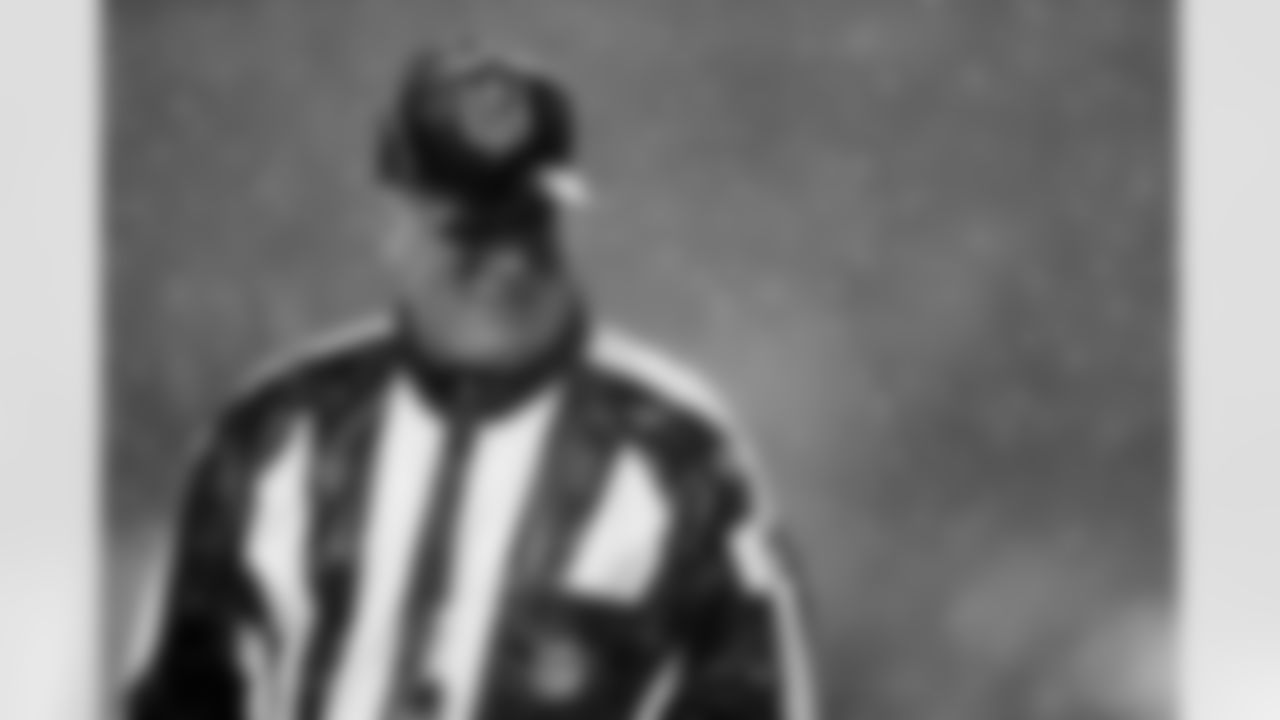 Field judge John Lucivansky (89) walks through the rain before an AFC divisional NFL playoff football game between the Indianapolis Colts and New England Patriots in Foxborough, Mass., Saturday, Jan. 11, 2014. (AP Photo/Michael Dwyer)