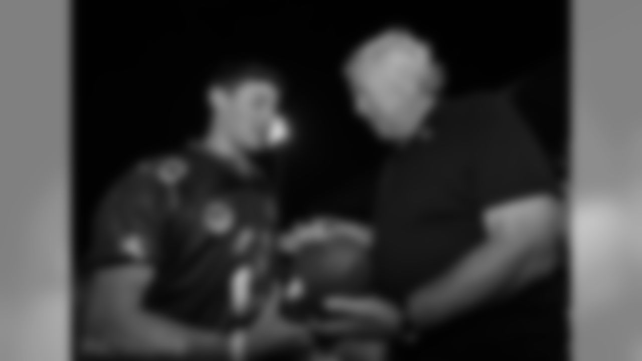 Robert Kraft signes a football for a member of the Israeli Football League.