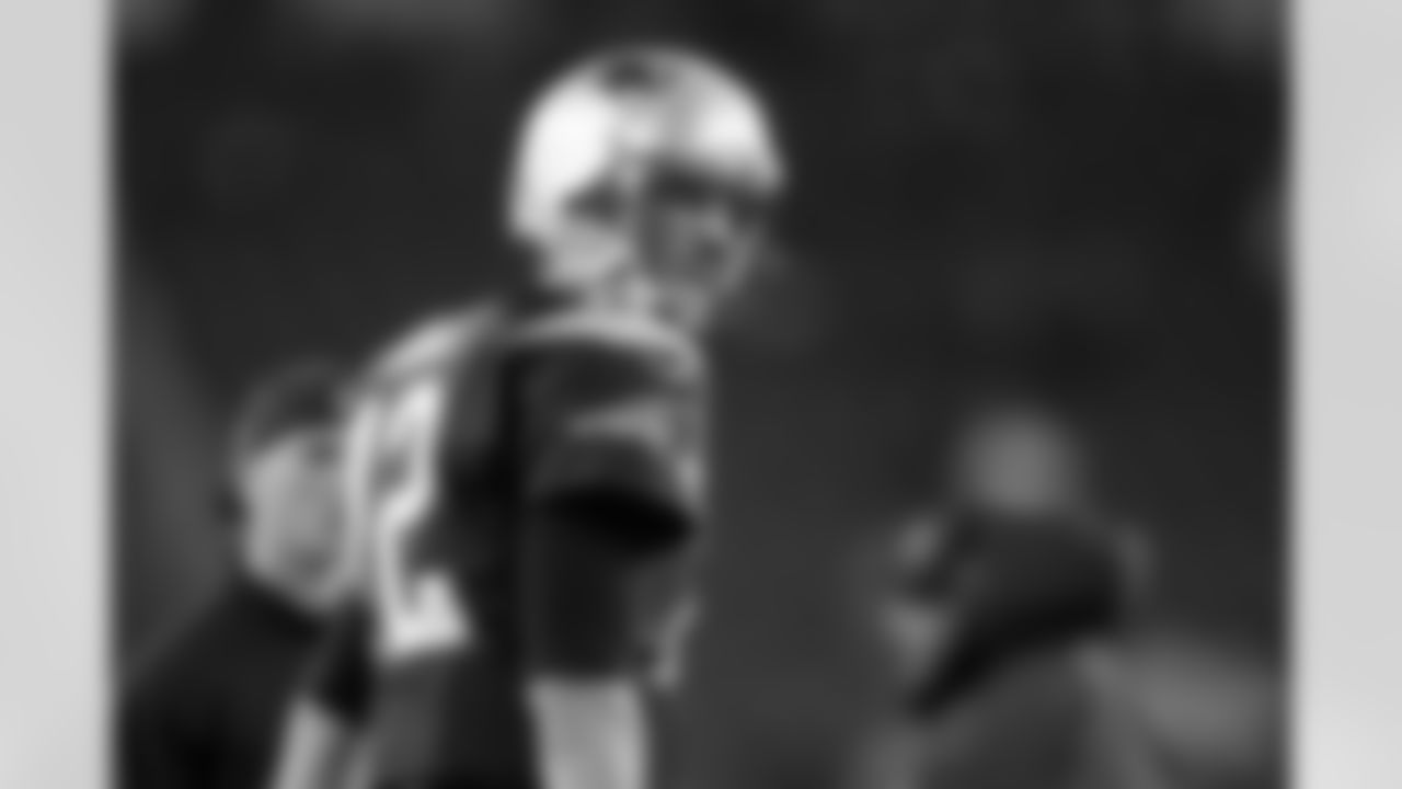 New England Patriots quarterback Tom Brady looks over his shoulder as he walks across the field before an AFC divisional NFL playoff football game against the Indianapolis Colts in Foxborough, Mass., Saturday, Jan. 11, 2014. (AP Photo/Michael Dwyer)