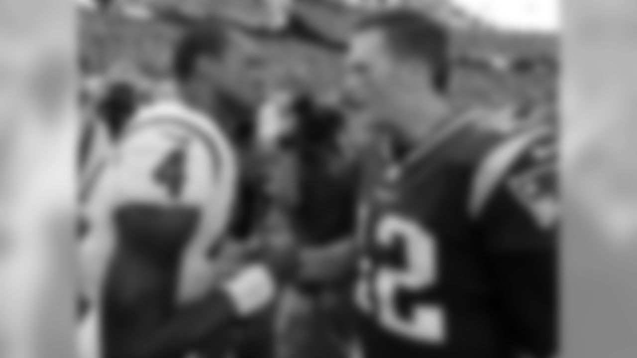 Houston Texans quarterback Deshaun Watson, left, and New England Patriots quarterback Tom Brady speak at midfield after an NFL football game, Sunday, Sept. 24, 2017, in Foxborough, Mass. (AP Photo/Steven Senne)