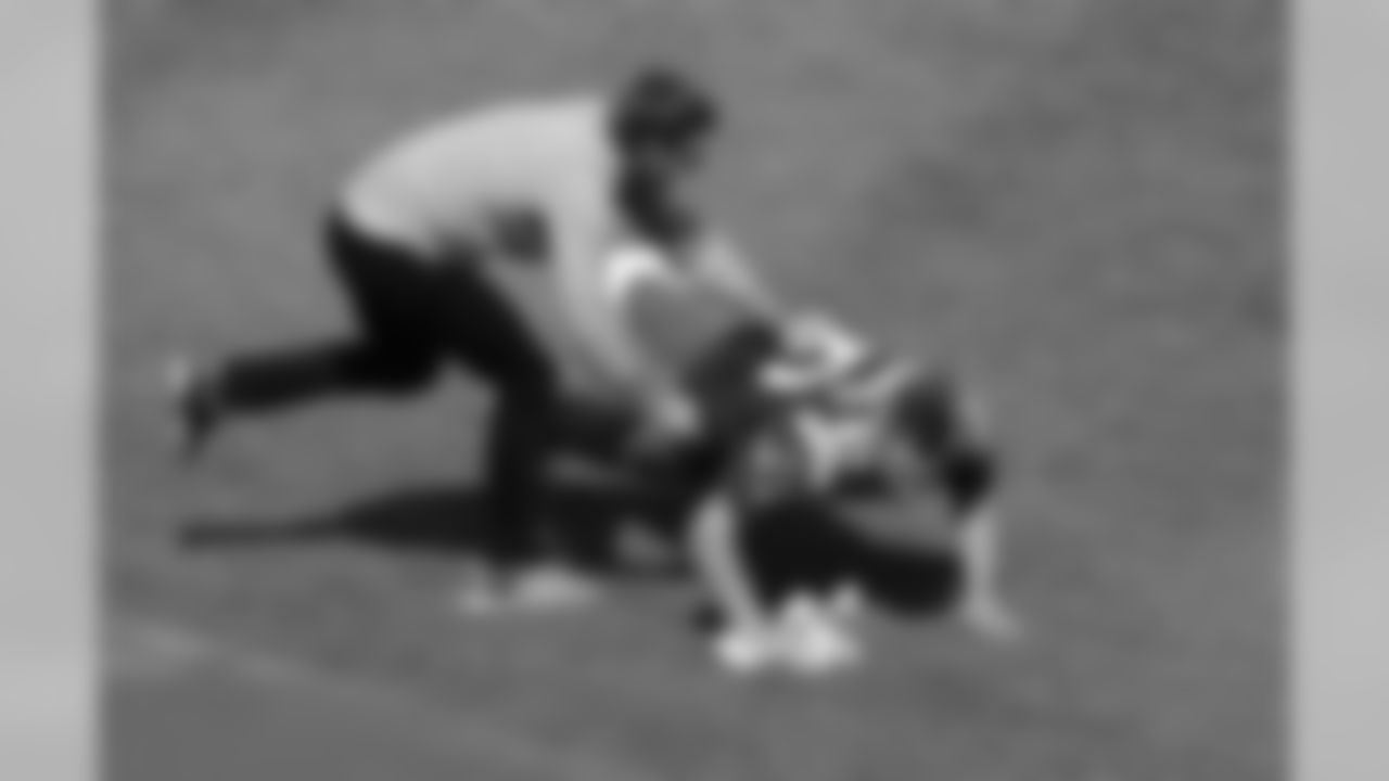 New England Patriots quarterback Tom Brady, left, tackles tight end Rob Gronkowski, right, who had grabbed Brady's recovered jersey, which was stolen from the locker room after the Patriots' February Super Bowl victory over the Atlanta Falcons in Houston, during pregame ceremonies before a baseball game between the Boston Red Sox and the Pittsburgh Pirates on opening day at Fenway Park, Monday, April 3, 2017, in Boston. (AP Photo/Steven Senne)