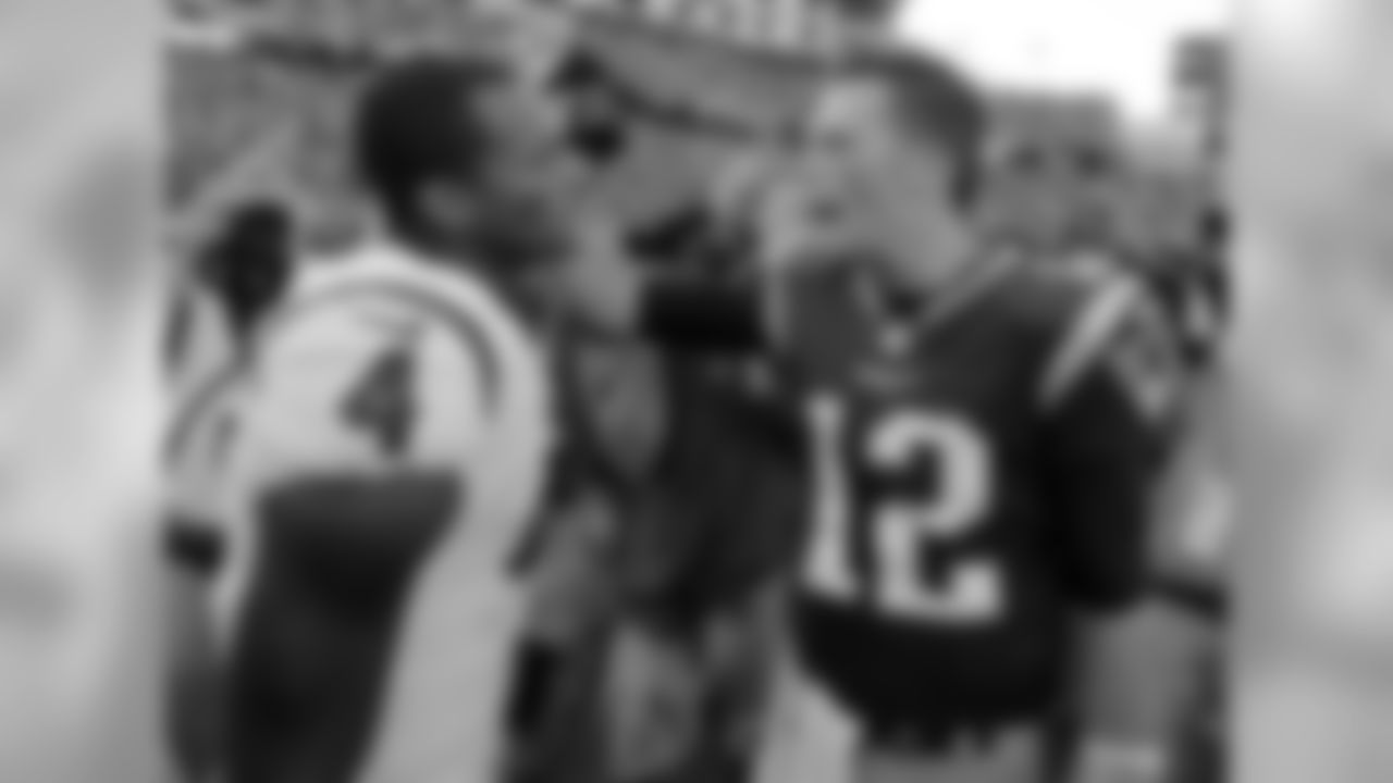 Houston Texans quarterback Deshaun Watson, left, and New England Patriots quarterback Tom Brady speak at midfield after an NFL football game, Sunday, Sept. 24, 2017, in Foxborough, Mass. (AP Photo/Steven Senne)