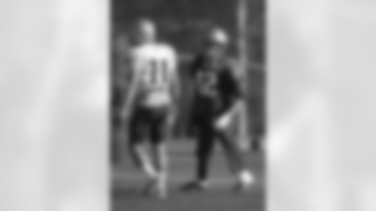 New England Patriots quarterback Tom Brady, right, stretches while warming up as wide receiver Julian Edelman, left, walks on the field during an NFL football practice, Wednesday, Nov. 4, 2015, in Foxborough, Mass. The Washington Redskins are to play the Patriots Sunday, Nov. 8, 2015, in Foxborough. (AP Photo/Steven Senne)