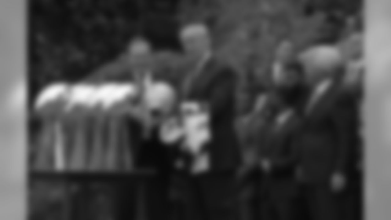 President Donald Trump is presented a New England Patriots helmet and jersey from Patriots head coach Bill Belichick, left, accompanied by owner Robert Kraft, right, during a ceremony on the South Lawn of the White House in Washington, Wednesday, April 19, 2017, where the president honored the Super Bowl Champion New England Patriots for their Super Bowl LI victory. (AP Photo/Susan Walsh)