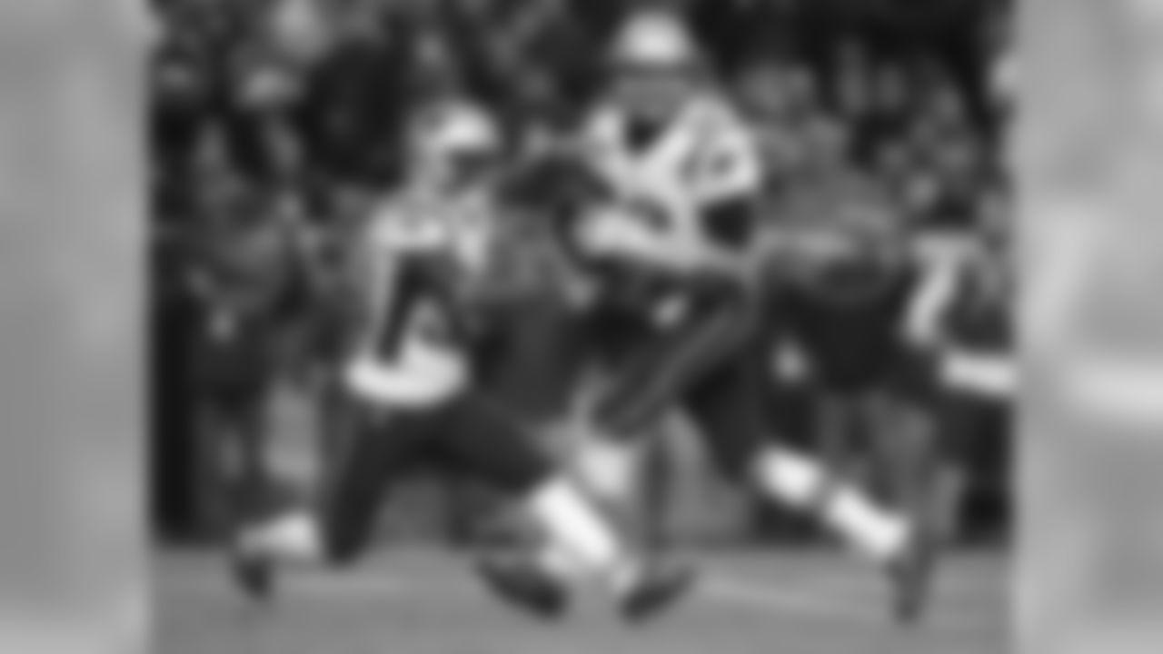 New England Patriots quarterback Tom Brady (12) looks to pass as running back Dion Lewis (33) runs during the second half of an NFL football game against the Denver Broncos, Sunday, Nov. 12, 2017, in Denver. (AP Photo/Jack Dempsey)