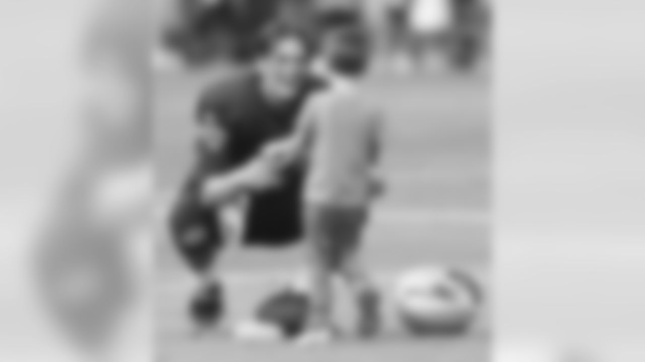 New England Patriots' Tom Brady greets his son Jack on the field after NFL football training camp Tuesday, Aug. 9, 2011, in Foxborough, Mass. (AP Photo/Michael Dwyer)