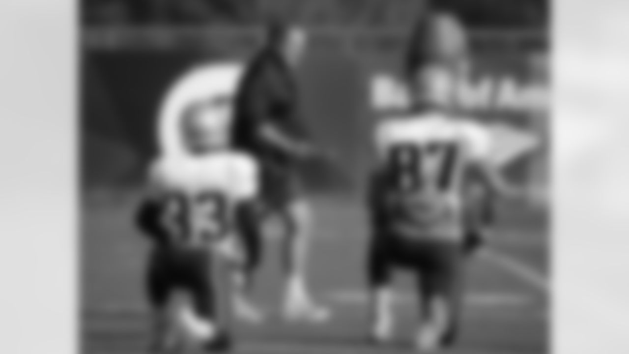 New England Patriots head coach Bill Belichick, center, walks past running back Dion Lewis, left, and tight end Rob Gronkowski, right, during an NFL football practice, Wednesday, Nov. 4, 2015, in Foxborough, Mass. The Washington Redskins are to play the Patriots Sunday, Nov. 8, 2015, in Foxborough. (AP Photo/Steven Senne)