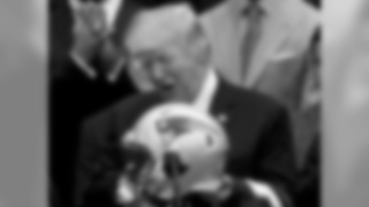 President Donald Trump is presented with a New England Patriots football helmet by Patriots head coach Bill Belichick and New England Patriots owner Robert Kraft during a ceremony on the South Lawn of the White House in Washington, Wednesday, April 19, 2017, where the president honored the Super Bowl Champion New England Patriots for their Super Bowl LI victory. (AP Photo/Andrew Harnik)