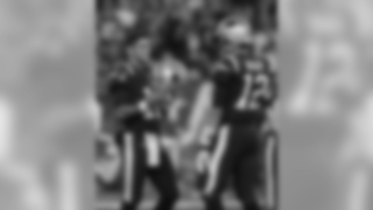 New England Patriots quarterbacks Jimmy Garoppolo, left, and Tom Brady speak while warming up before an NFL football game against the Atlanta Falcons, Sunday, Oct. 22, 2017, in Foxborough, Mass. (AP Photo/Charles Krupa)
