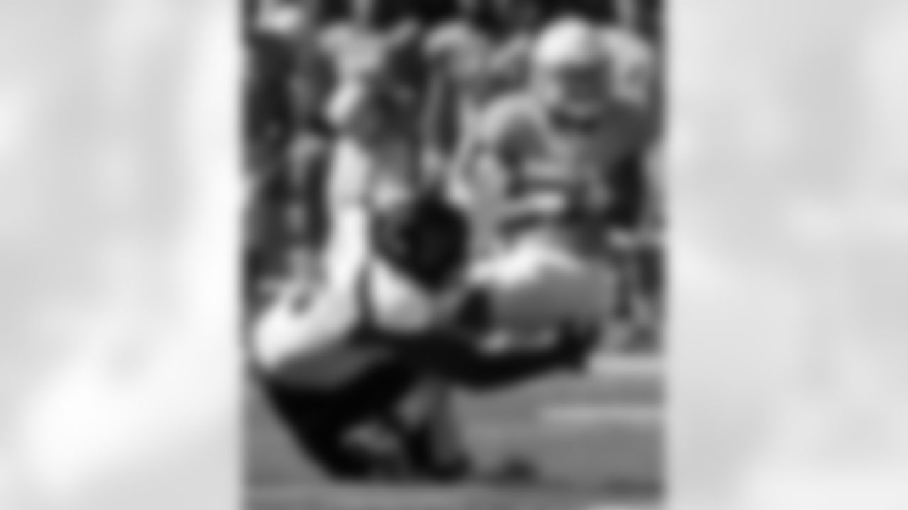 Kansas safety Keeston Terry (9) is tackled by Texas Tech tackle LaAdrian Waddle (65) after an interception during the first half of an NCAA college football game in Lawrence, Kan., Saturday, Oct. 1, 2011. (AP Photo/Orlin Wagner)