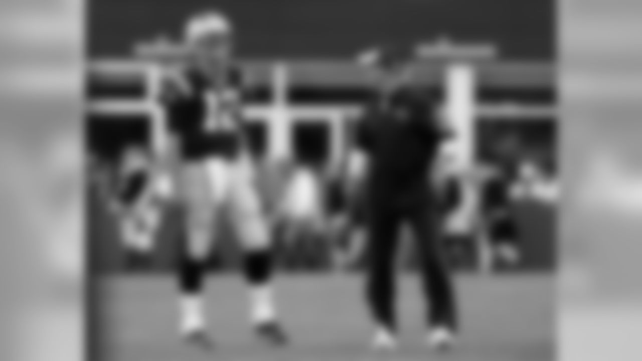 New England Patriots quarterback Tom Brady (12) and offensive coordinator Josh McDaniels share a laugh before an NFL preseason football game against the Green Bay Packers Thursday, Aug. 13, 2015, in Foxborough, Mass. (AP Photo/Charles Krupa)