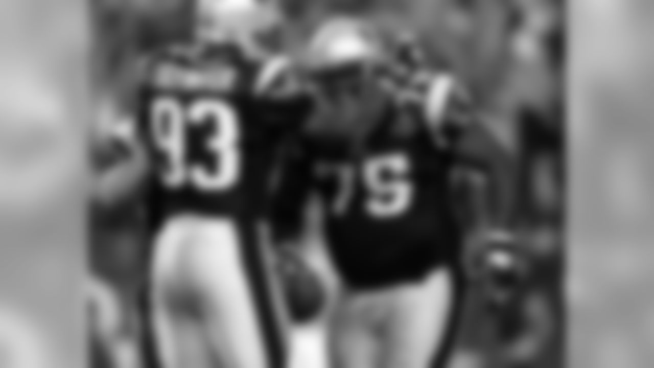 FOXBORO, MA - SEPTEMBER 8: Defensive lineman Vince Wilfork #75 of the New England Patriots is congratulated by teammate Richard Seymour #93 after an interception against the Oakland Raiders during the 2005 NFL opening game at Gillette Stadium on September 8, 2005 in Foxboro, Massachusetts. (Photo by Nick Laham/Getty Images)