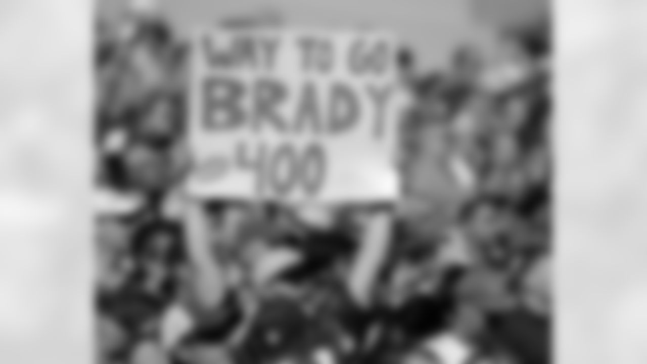 A fan celebrates the 400th career touchdown pass by New England Patriots quarterback Tom Brady in the first half of an NFL football game against the Jacksonville Jaguars, Sunday, Sept. 27, 2015, in Foxborough, Mass. (AP Photo/Steven Senne)