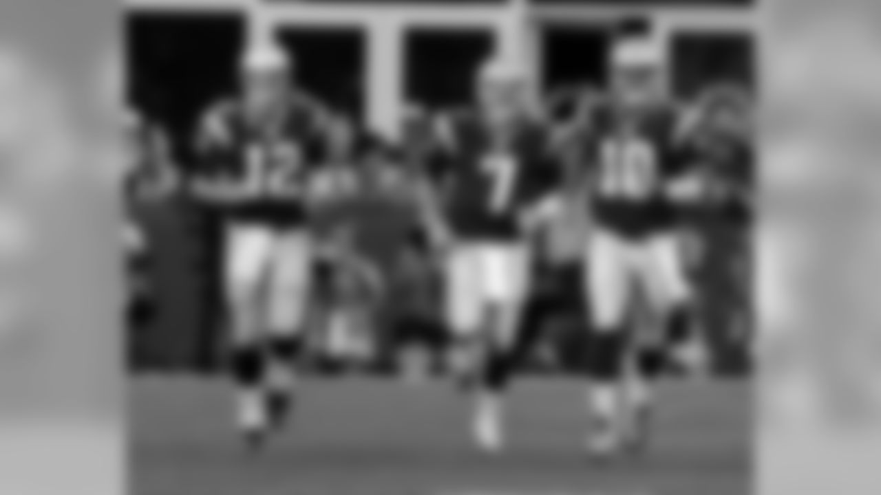 New England Patriots quarterbacks Tom Brady (12), Ryan Lindley (7) and Jimmy Garoppolo (10) warms up before an NFL preseason football game against the Green Bay Packers Thursday, Aug. 13, 2015, in Foxborough, Mass. (AP Photo/Charles Krupa)