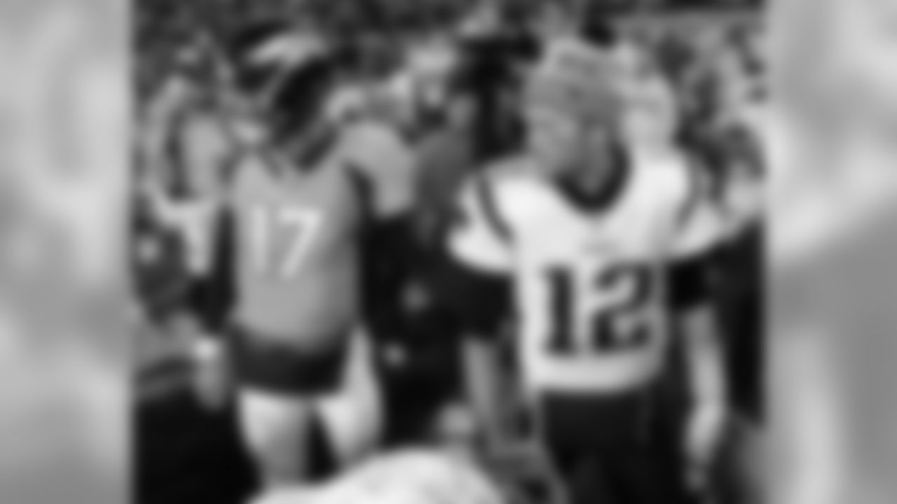 New England Patriots quarterback Tom Brady (12) and Denver Broncos quarterback Brock Osweiler (17) meet after an NFL football game, Sunday, Nov. 12, 2017, in Denver. The Patriots won 41-16. (AP Photo/Jack Dempsey)
