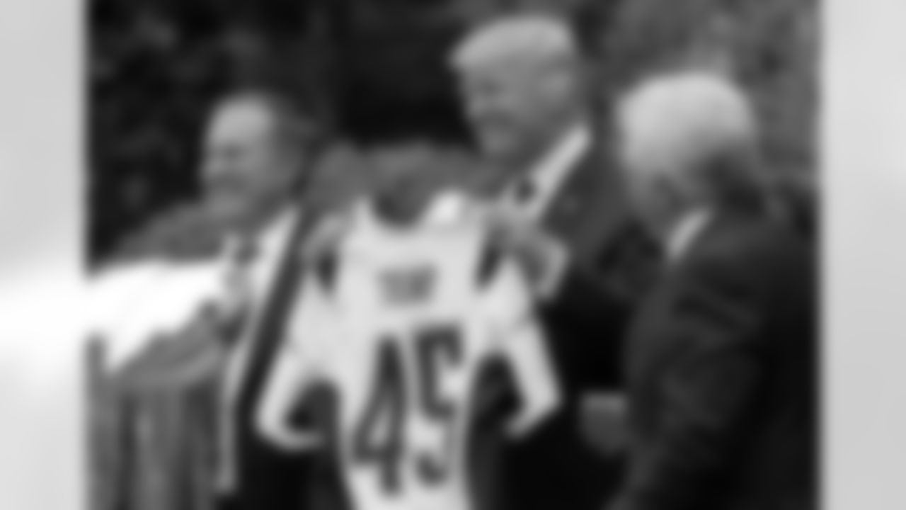 President Donald Trump holds up a New England Patriots jersey presented to him by Patriots owner Robert Kraft, right, and head coach Bill Belichick during a ceremony on the South Lawn of the White House in Washington, Wednesday, April 19, 2017, where the president honored the Super Bowl Champion New England Patriots for their Super Bowl LI victory. (AP Photo/Susan Walsh)