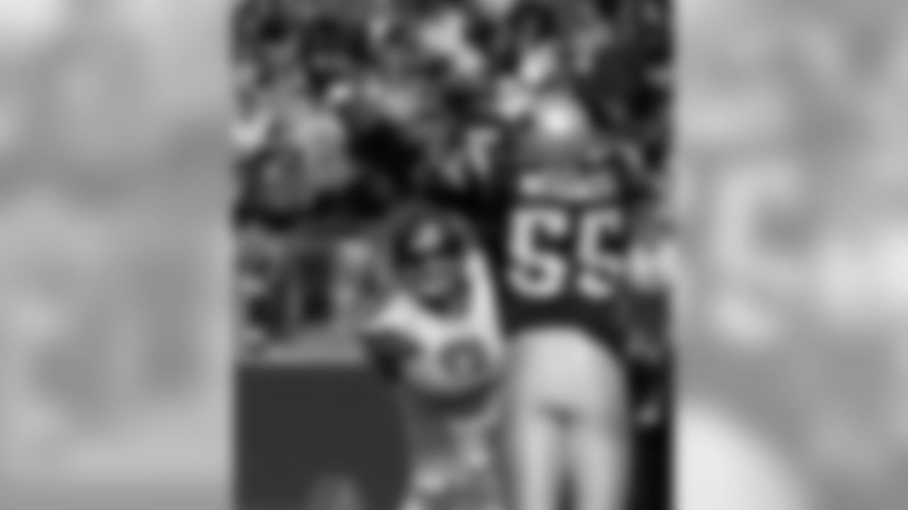 Seattle Seahawks quarterback Matt Hasselbeck (8) passes around the out stretched arms of New England Patriots linebacker Willie McGinest (55) during second quarter action of their NFL game Sunday afternoon Oct. 17, 2004 in Foxboro Mass. (AP Photo/Stephan Savoia)