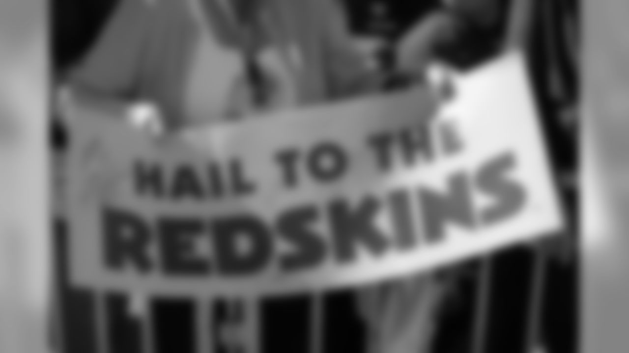Redskin fans hold up a sign to support their team.