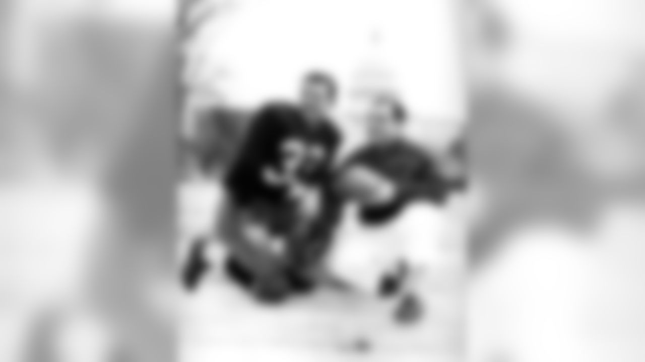 1950 - Quarterback Sammy Baugh of the Washington Redskins with the Redskins equipment man Kelly Miller in a 1950 photo. Sammy Baugh - Washington Redskins - File Photos (AP Photo/NFL Photos)