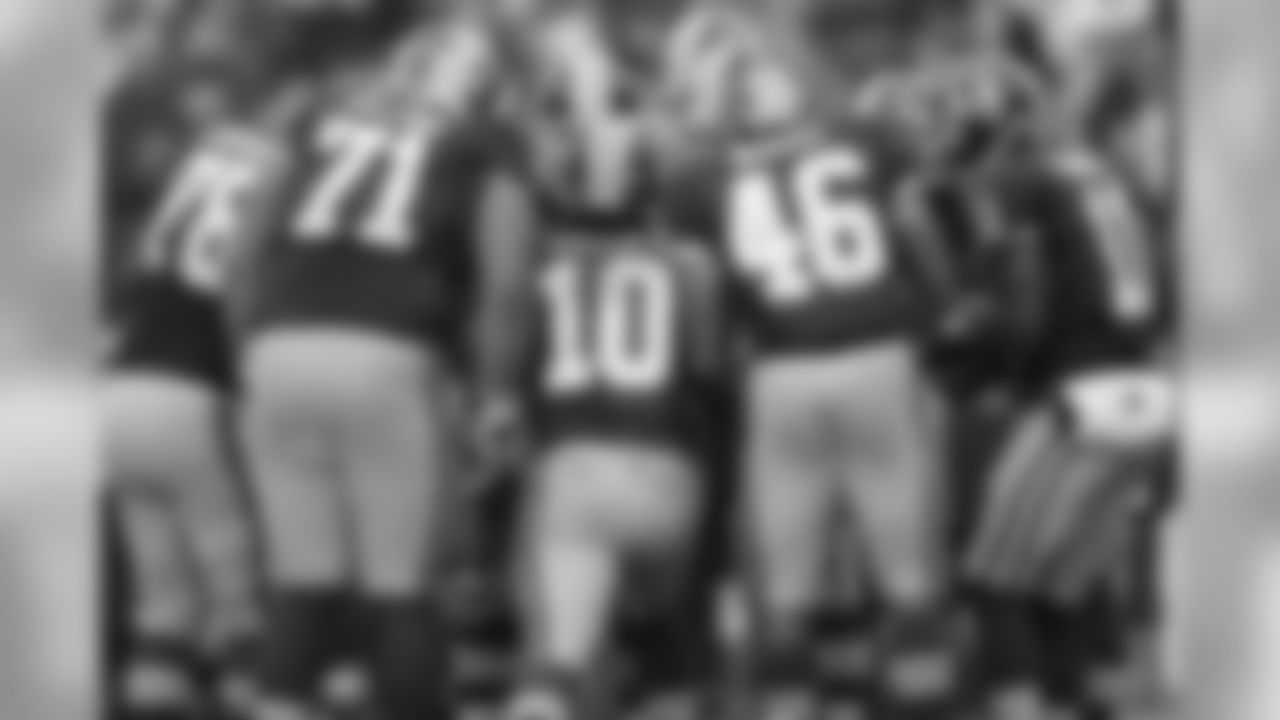 The Redskins offense huddles before a play.