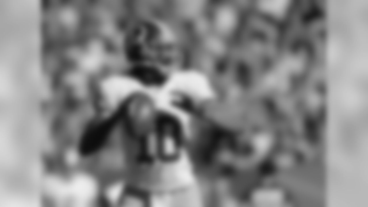 Quarterback Robert Griffin III looks for a receiver down field on Sunday, Oct. 27, 2013, in Denver.