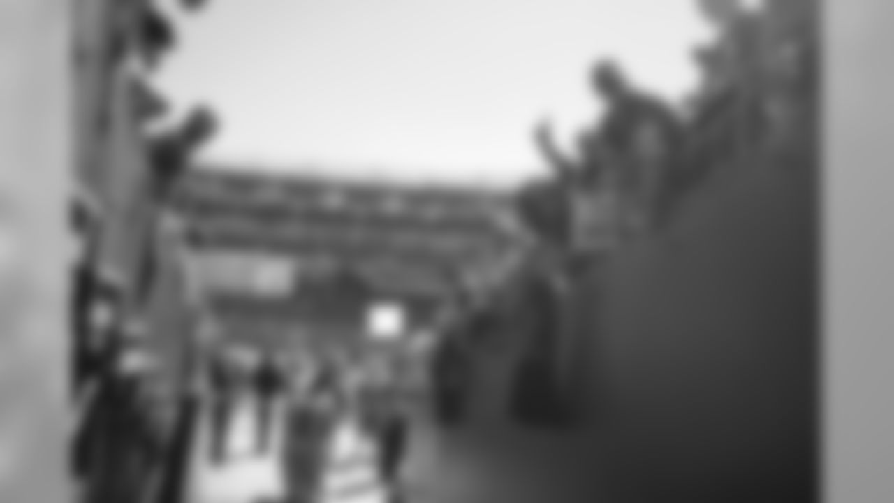 Redskins players greet fans in the tunnel before the game