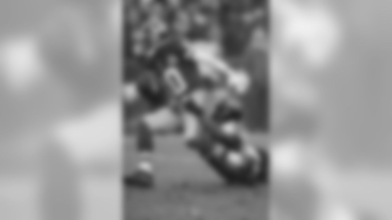 Redskins QB Robert Griffin III breaks a tackle on a run.