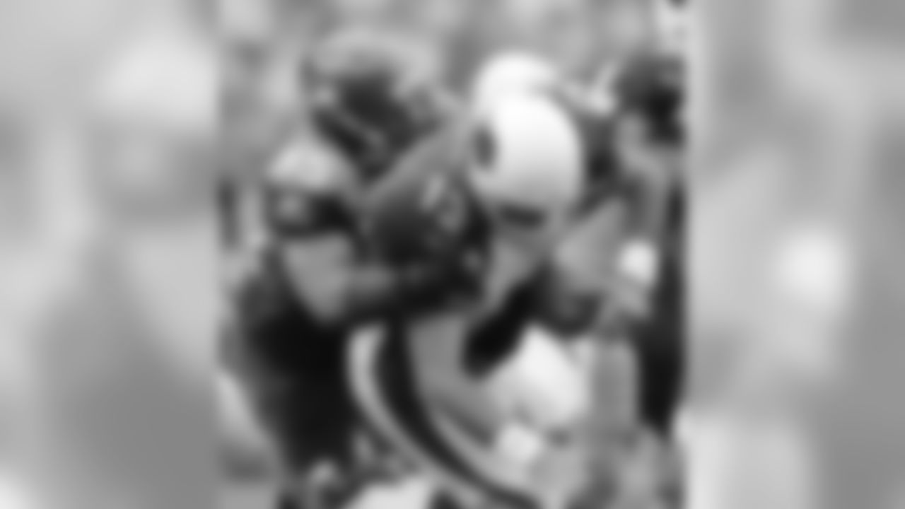 * FILE * Arizona Cardinals quarterback Kurt Warner loses control of the ball but regains control as he is sacked by Seattle Seahawks' Darryl Tapp during the fourth quarter of a football game in Seattle, in this Sept. 17, 2006 file photo. One week after Warner was named NFC offensive player of the week in Arizona's season-opening victory over San Francisco, he was blamed, in part, by his coach for the offense's struggles in Sunday's 21-10 loss at Seattle. (AP Photo/John Froschauer)