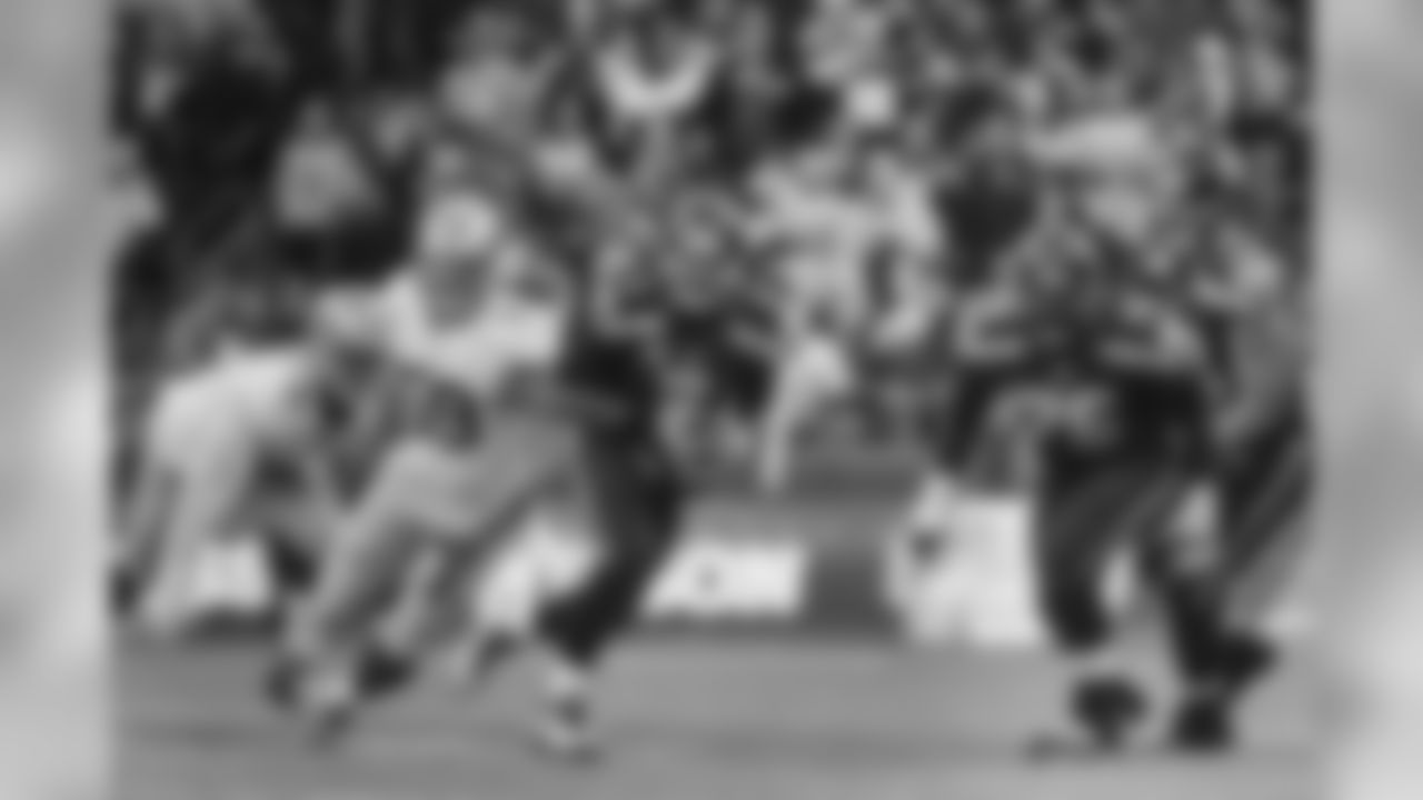 Seattle quarterback Russell Wilson leaves the pocket and scrambles to his left.