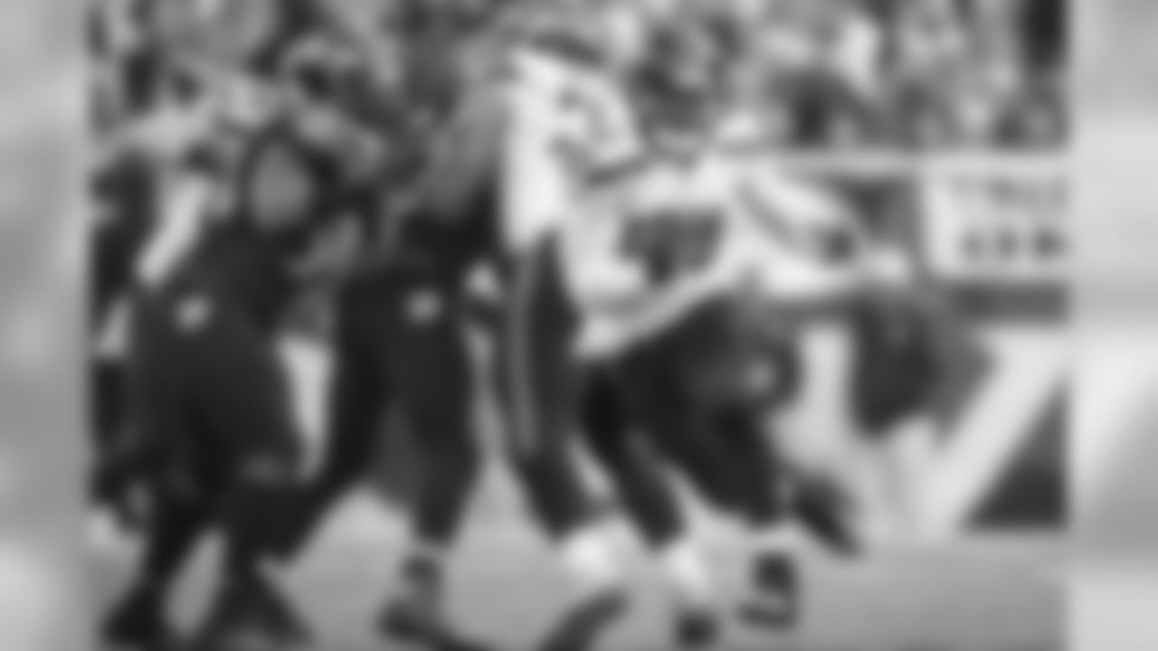 Derrick Coleman sprints upfield for a 19-yard gain as teammates Cooper Helfet and Garry Gilliam seal off Baltimore defenders.