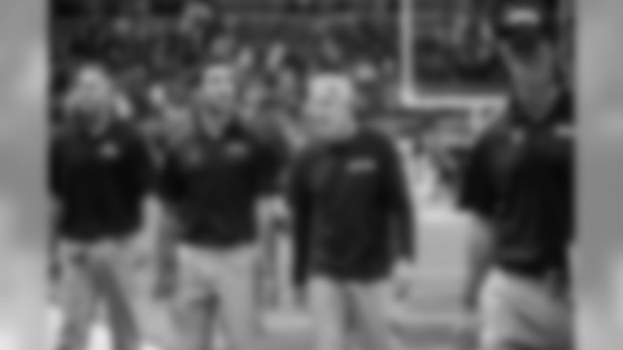 Seattle's Pete Carroll, with assistant coach Nate Carroll, leaves the field after the tough 28-26 loss to the Rams.