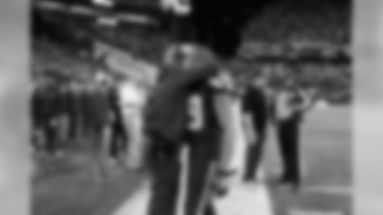 Head coach Pete Carroll hugs receiver Doug Baldwin just before kickoff.