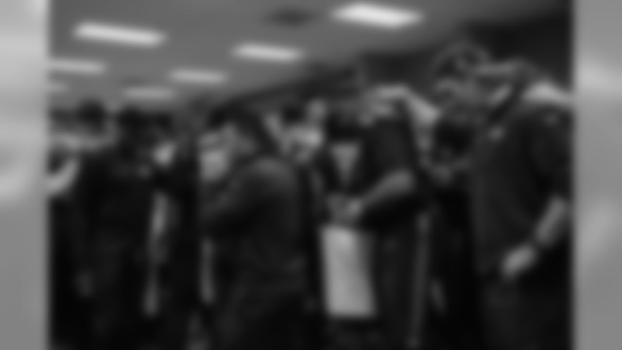 Seahawks players, coaches and staff huddle for the last time of a season which saw them become the first team to return to the Super Bowl after winning it in over a decade.