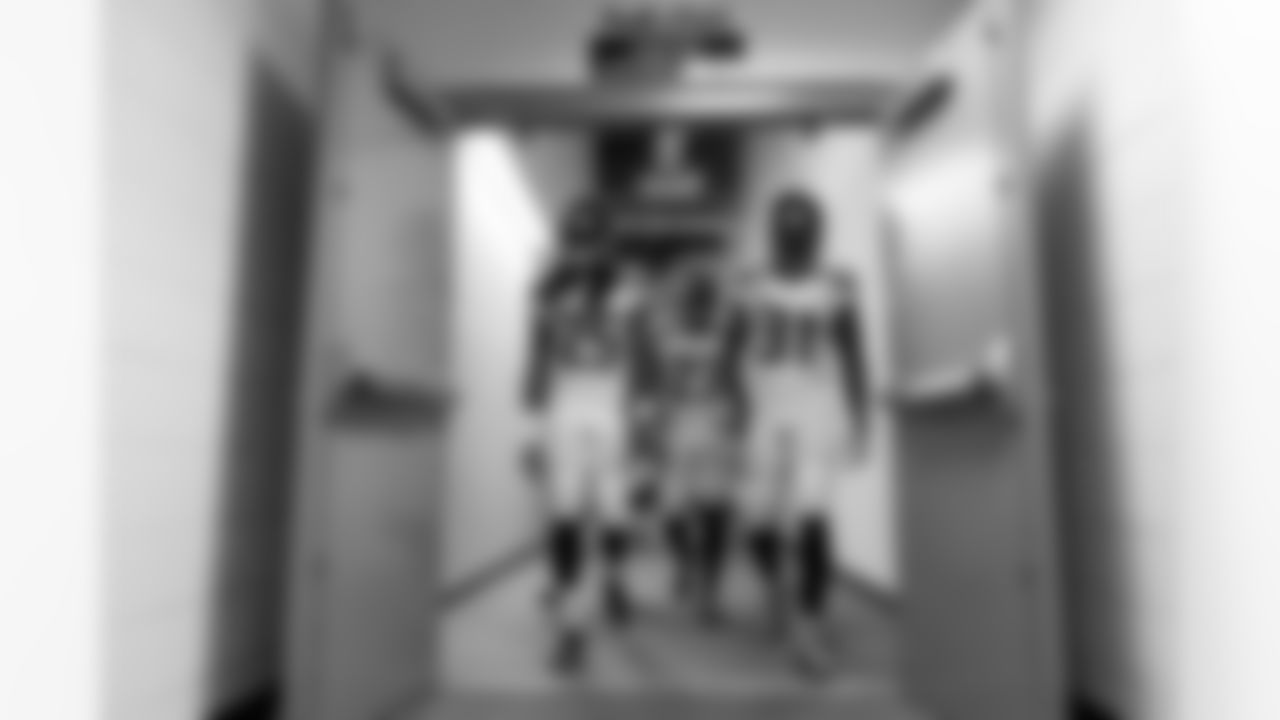 Legion of Boom members Richard Sherman, Jeron Johnson and Kam Chancellor head from the locker room to the playing field.