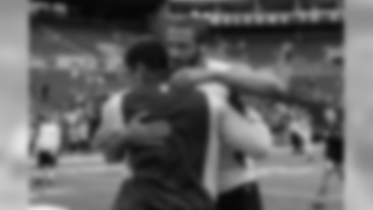 Quarterbacks Russell Wilson and Colin Kaepernick greet each other near midfield during pregame.