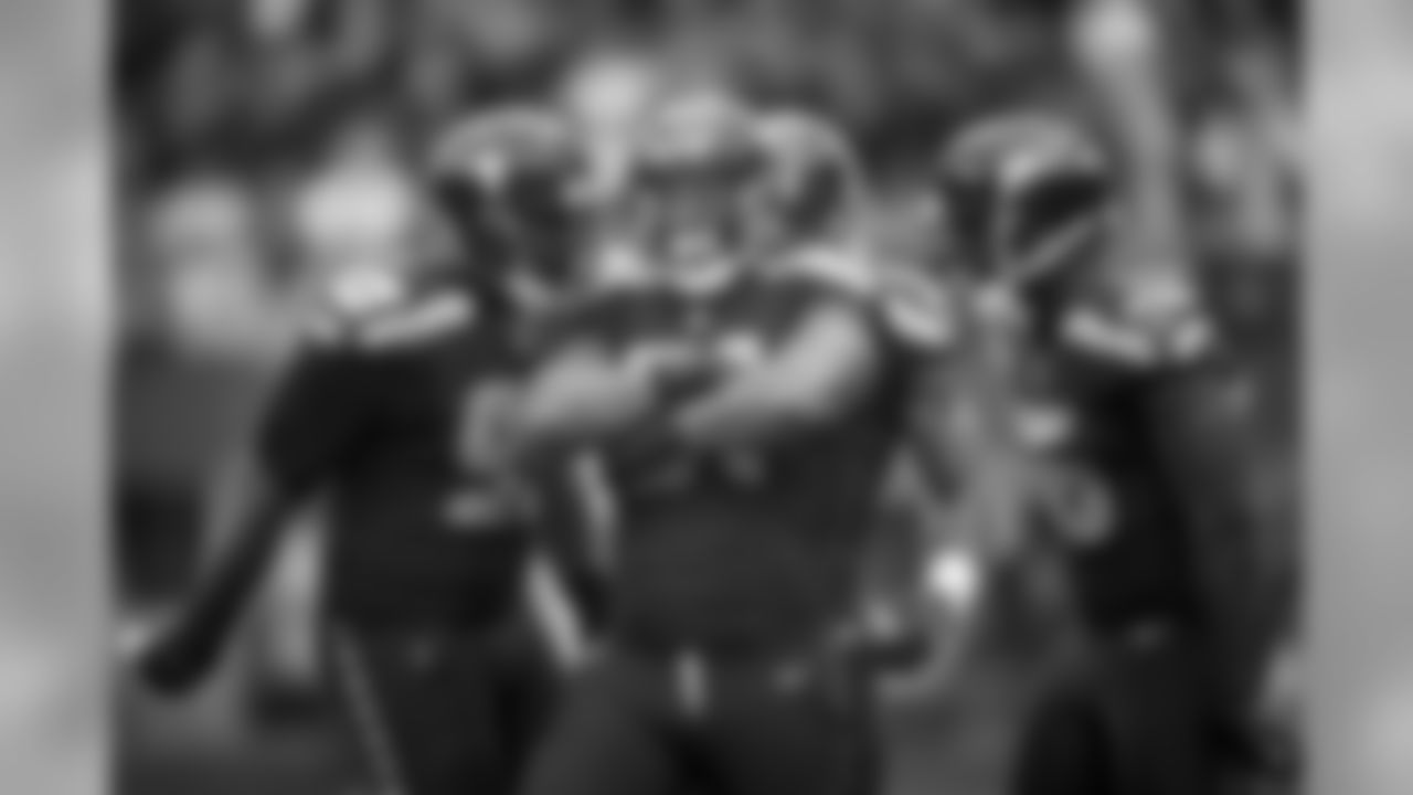 Bruce Irvin celebrates a tackle for loss with teammates Demarcus Hobbs and Cliff Avril