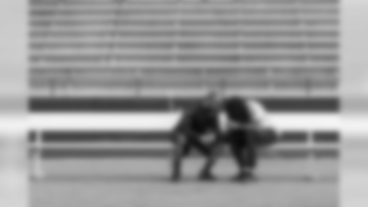Doug Baldwin and Richard Sherman break down video on a mobile device on the sidelines at St. Louis University High School at the end of walkthru.