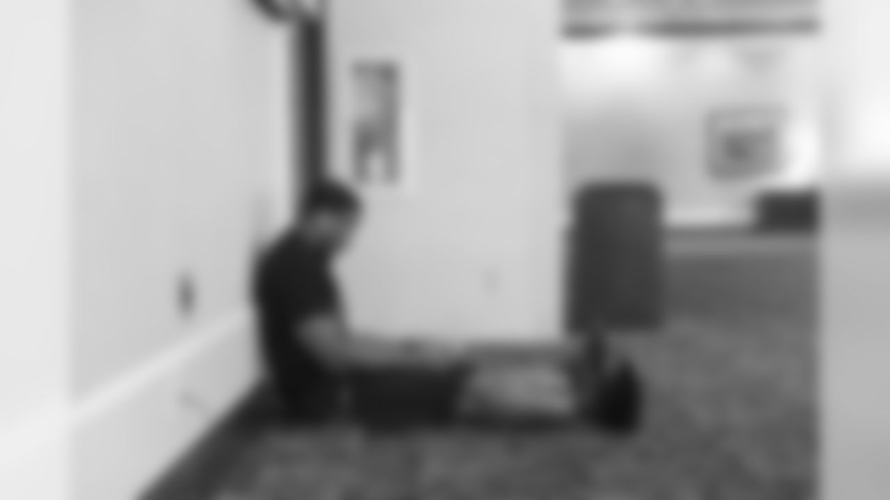 It's 10:45am on game day, and Bobby Wagner studies game footage outside of the conference room in the team hotel where walk thru is due to begin.