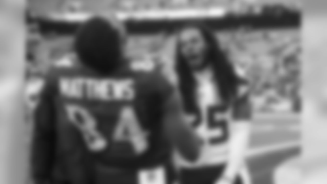 After the game, former teammates Chris Matthews and Richard Sherman share a laugh. Earlier in the game, Matthews tackled Sherman after an interception by grabbing his braids.