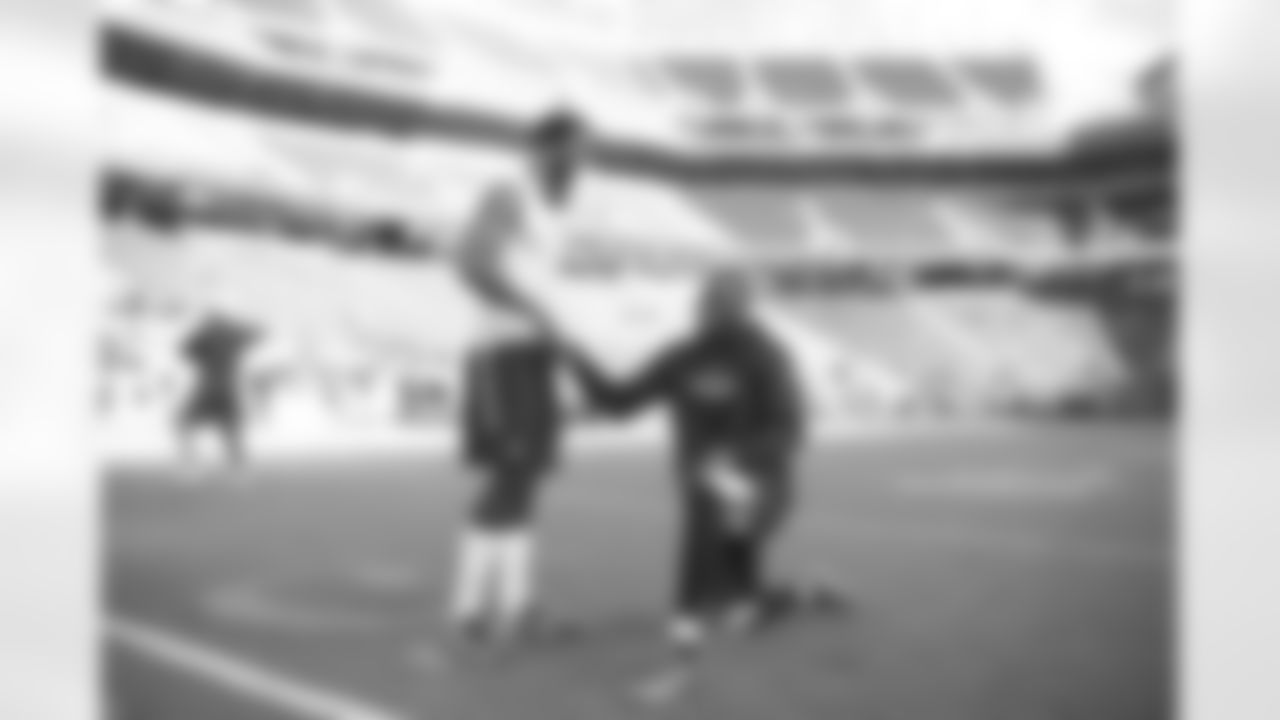 San Francisco quarterback Colin Kaepernick pays a pregame visit to former teammate and current Seahawks Ricardo Lockette near midfield hours before kickoff.