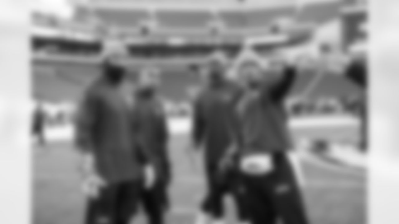 Once at the stadium, quarterbacks and receivers took to the field for their early warmups. Russell Wilson, Jermaine Kearse, Doug Baldwin and Kevin Norwood met near midfield to examine the path of the wind inside the bowl of the stadium.