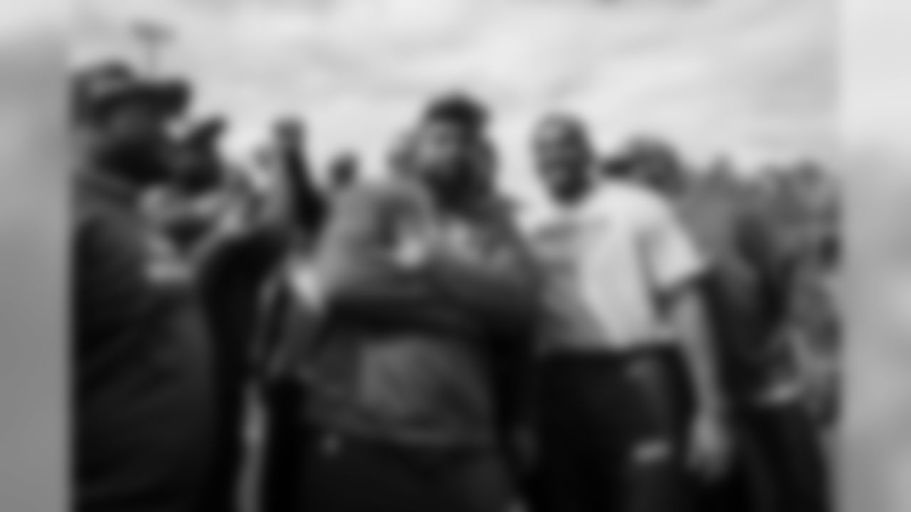 Defensive lineman Tony McDaniel turns a meeting of the D-line into his own personal photo shoot as the players try to break it down after walk thru.