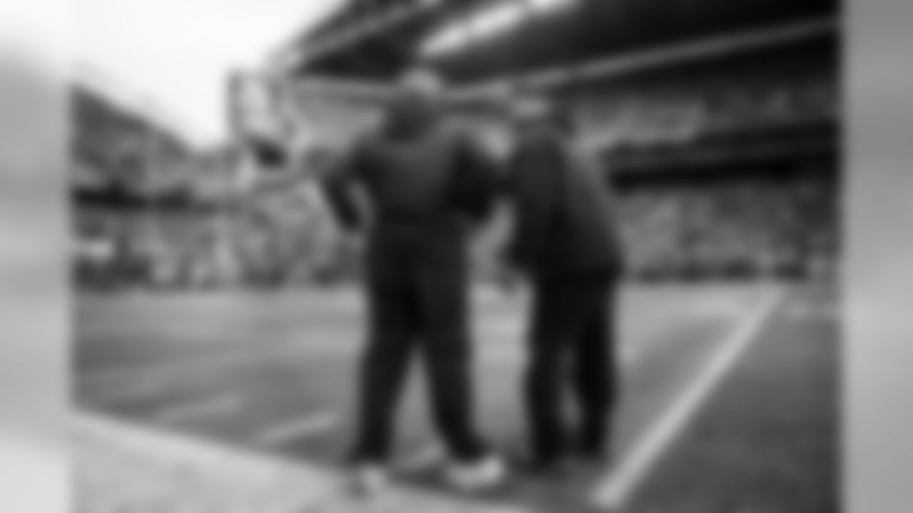 Head coach Pete Carroll and special teams coach Brian Schneider confer on the sidelines as Seattle lines up for a two-point conversion try, attempting to stretch their lead to a field goal with less than two minutes left in regulation.