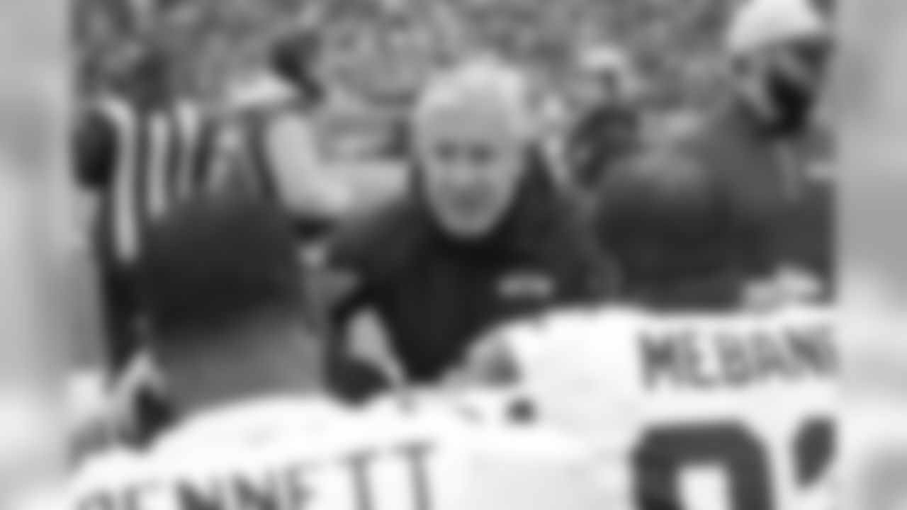 Head coach Pete Carroll walked back to the benches to confer with defensive linemen Michael Bennett and Brandon Mebane.